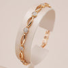 Fino bracelete de figuras ovaladas y circonitas blancas en baño de oro rosa de 18K