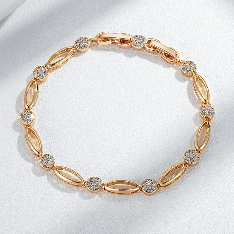 Fino bracelete de figuras ovaladas y circonitas blancas en baño de oro rosa de 18K