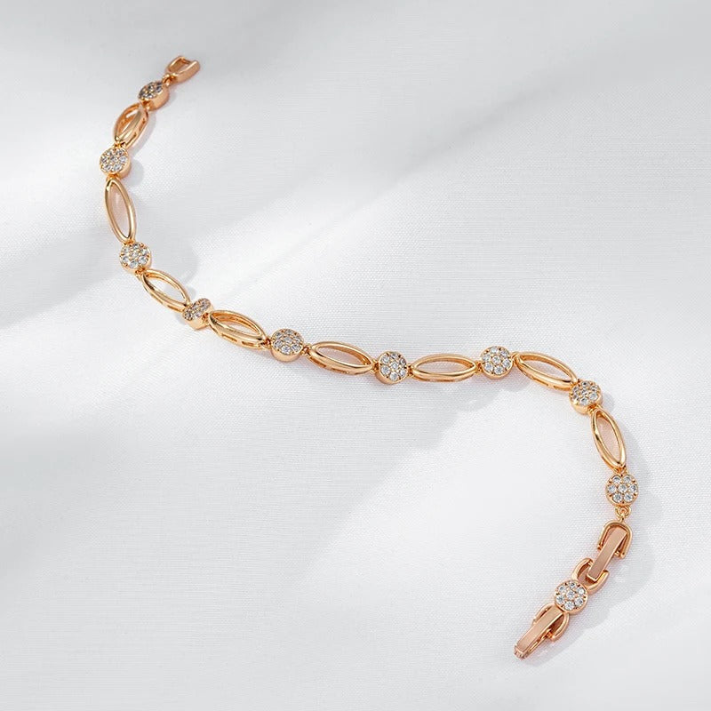 Fino bracelete de figuras ovaladas y circonitas blancas en baño de oro rosa de 18K